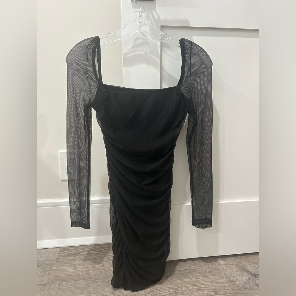 Black party dress with sheer long sleeves.